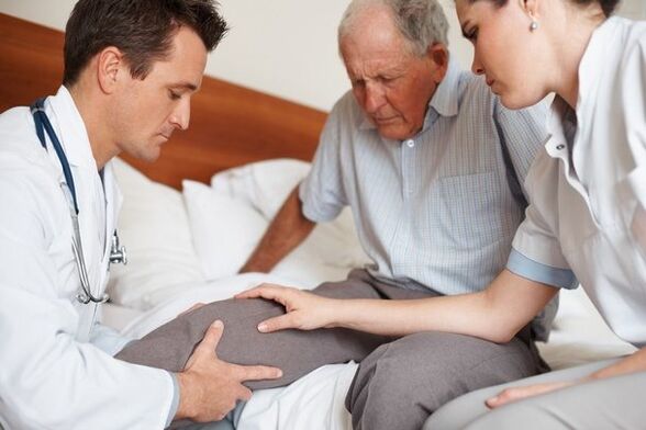 Doctor checking patient's knee